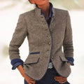 Women's textured stand collar tailored jacket with contrast trim and button front