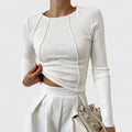 Women's ribbed long sleeve crop top with exposed seams and round neckline