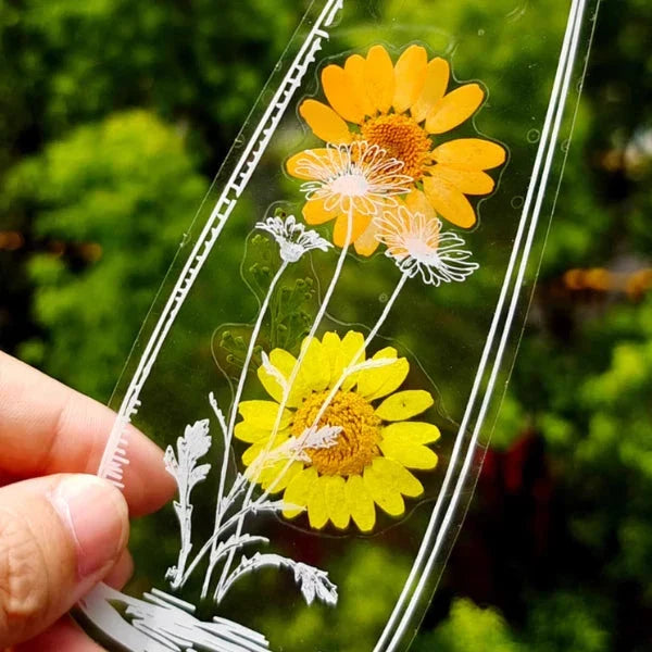 Clear pressed flower bookmark sheet with white floral outline designs