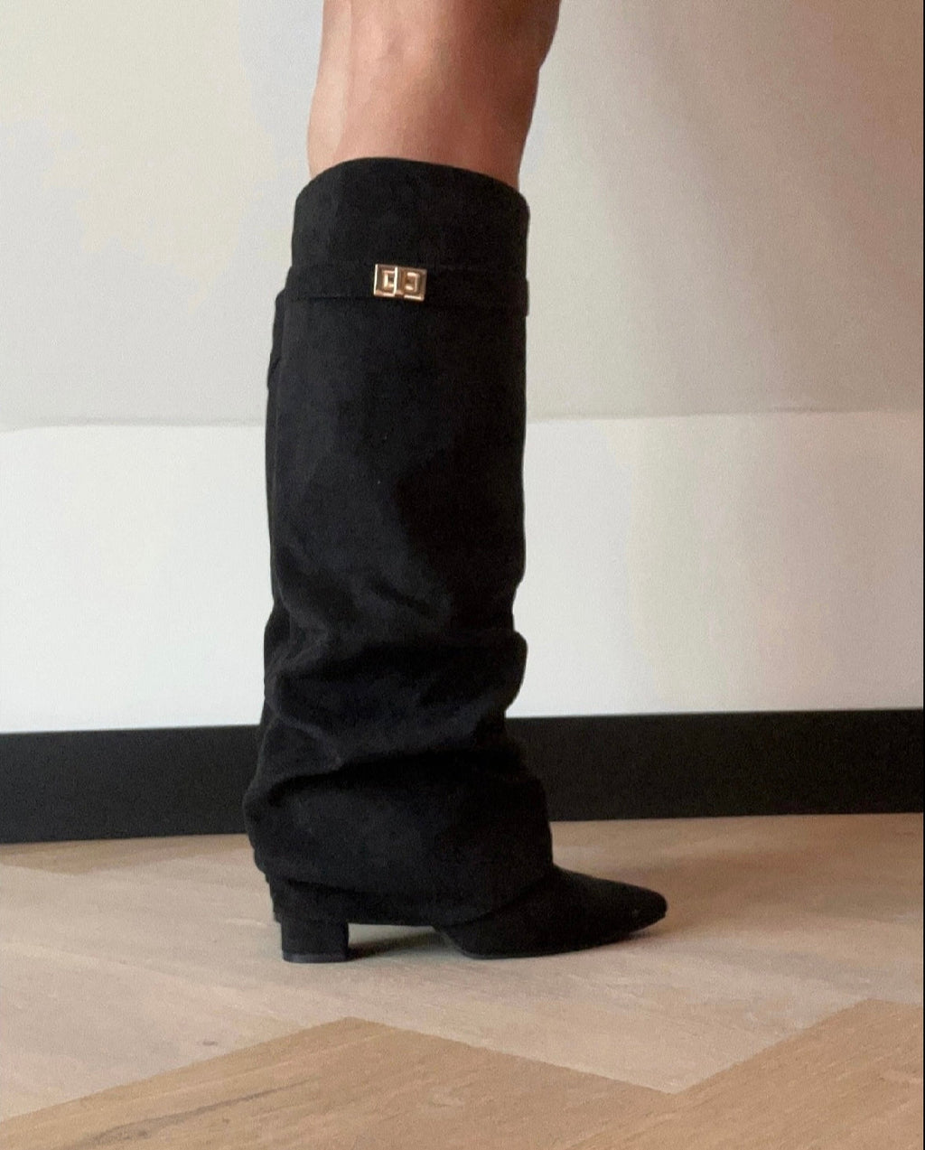 Black women's slouch knee-high boots with pointed toes and low block heels
