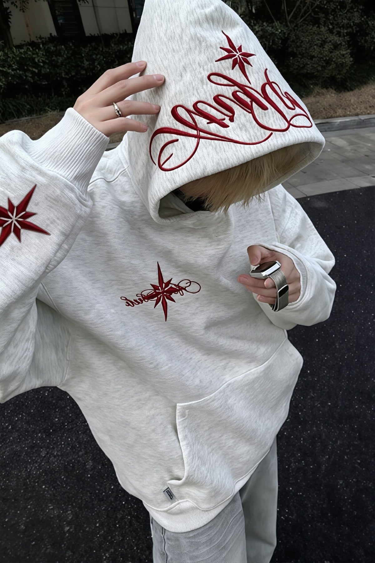 Pullover hoodie with embroidered star script, hood, long sleeves and front pouch pocket