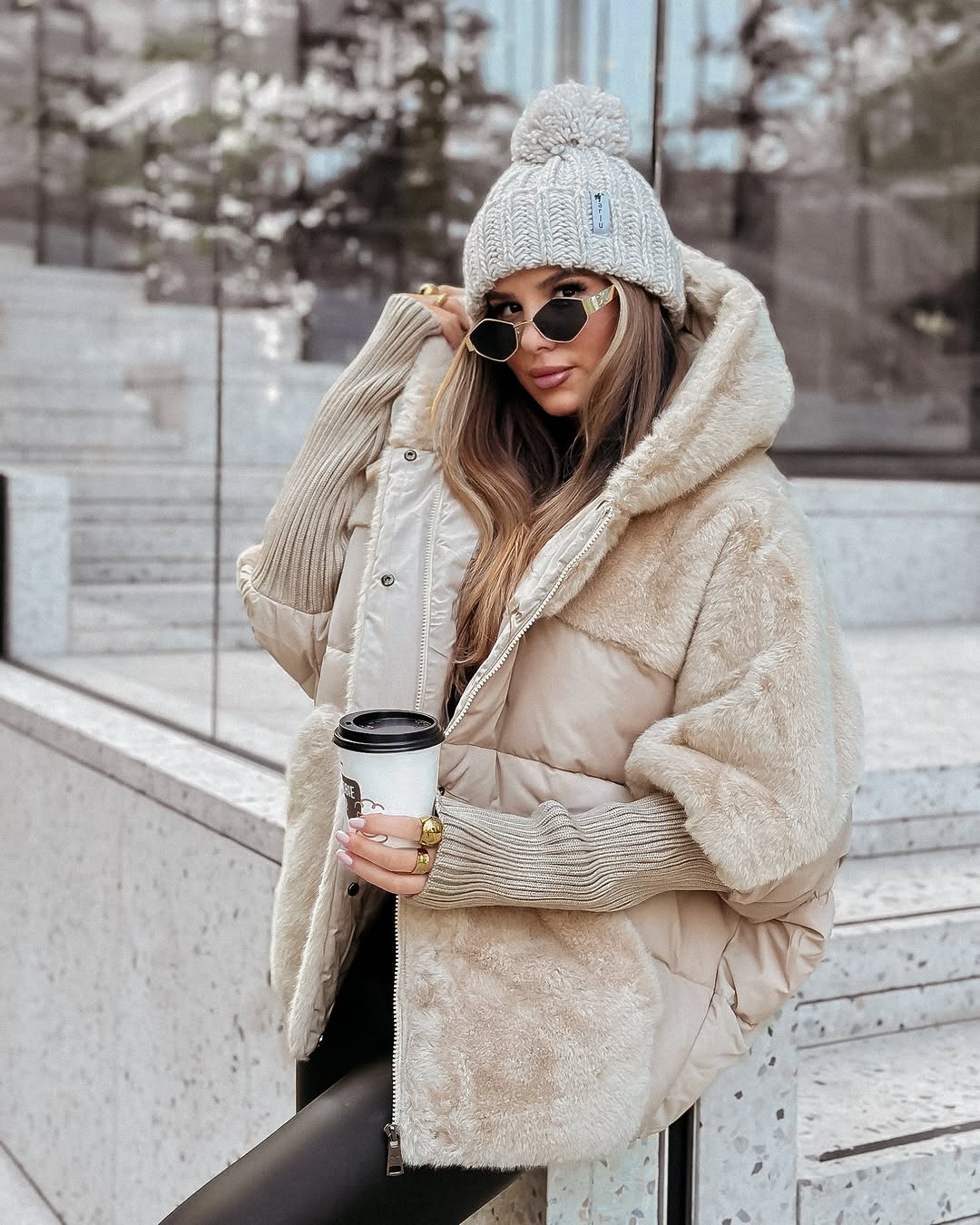 Women's oversized hooded puffer jacket with quilted and textured patchwork panels