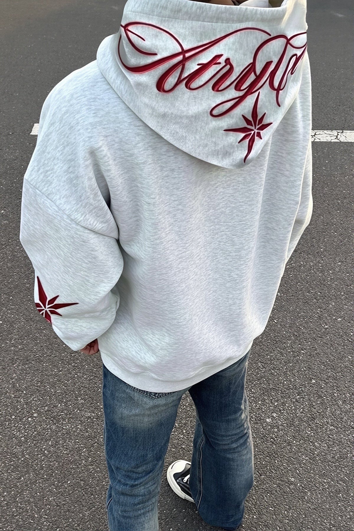 Pullover hoodie with embroidered star script, hood, long sleeves and front pouch pocket