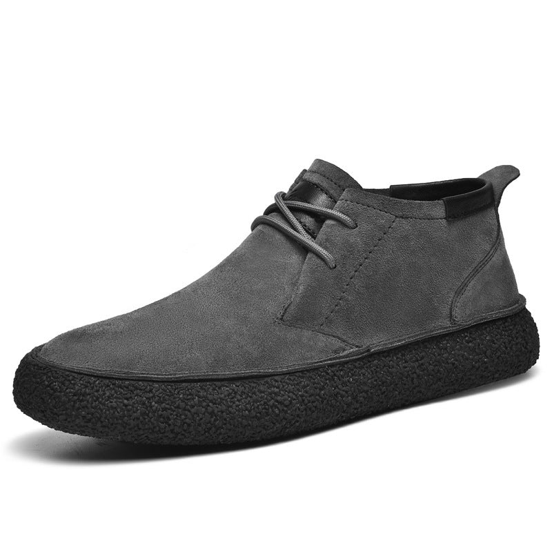Men's lace-up chukka ankle boots with rounded toes, dark collar trim and textured soles