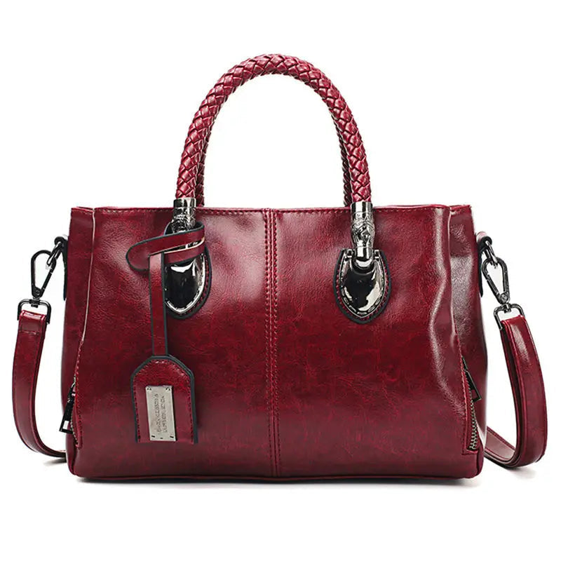 Structured handbag with braided handles, crossbody strap and hanging tag