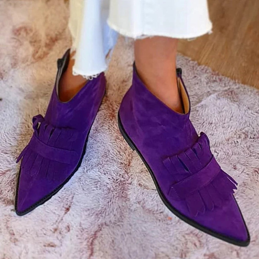 Purple pointed ankle boots with layered fringe panels and flat soles