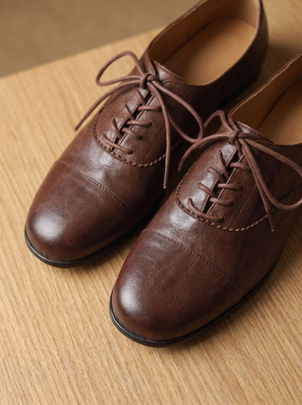 Women's brown cap toe lace-up Oxford shoes with low heels