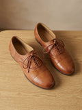 Women's brown cap toe lace-up Oxford shoes with low heels