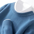 Men's textured knit crew neck sweater shown in light blue and black with long sleeves and ribbed edges