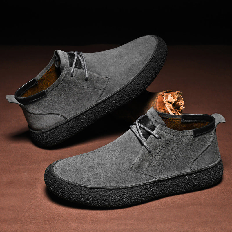 Men's lace-up chukka ankle boots with rounded toes, dark collar trim and textured soles