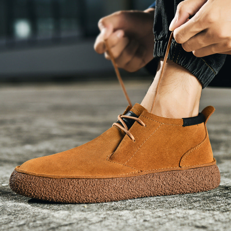 Men's lace-up chukka ankle boots with rounded toes, dark collar trim and textured soles