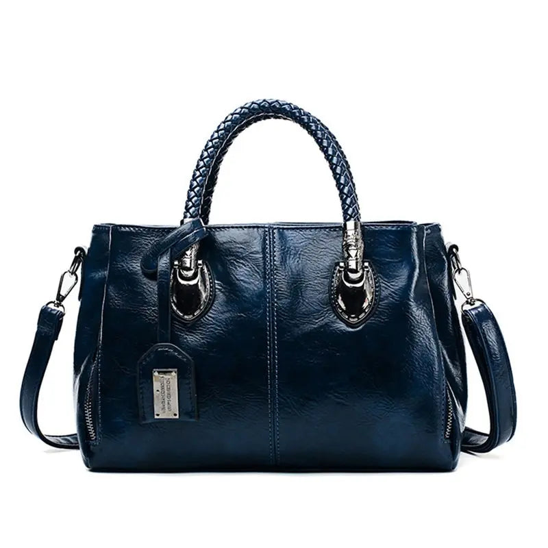Structured handbag with braided handles, crossbody strap and hanging tag