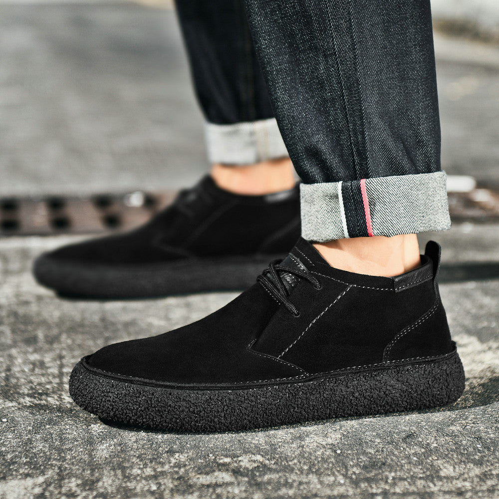 Men's lace-up chukka ankle boots with rounded toes, dark collar trim and textured soles