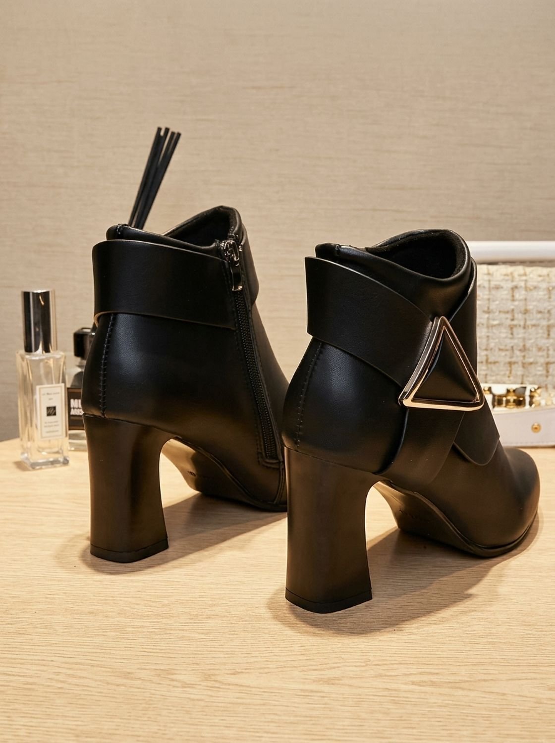 Women's pointed toe ankle boots with wraparound strap, triangular buckle and block heel