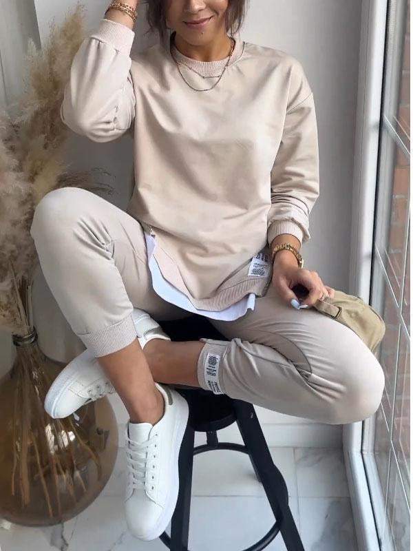 Women's crew neck sweatshirt and tapered jogger set with side zips and layered hem
