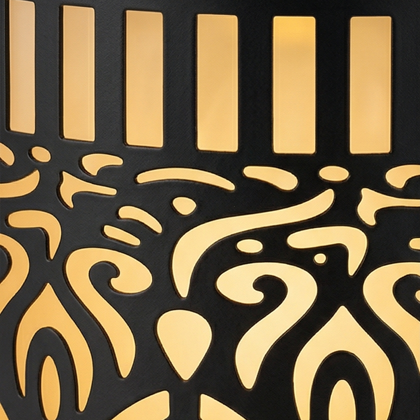 Black cylindrical solar lantern projecting warm patterned light on a wall and patio