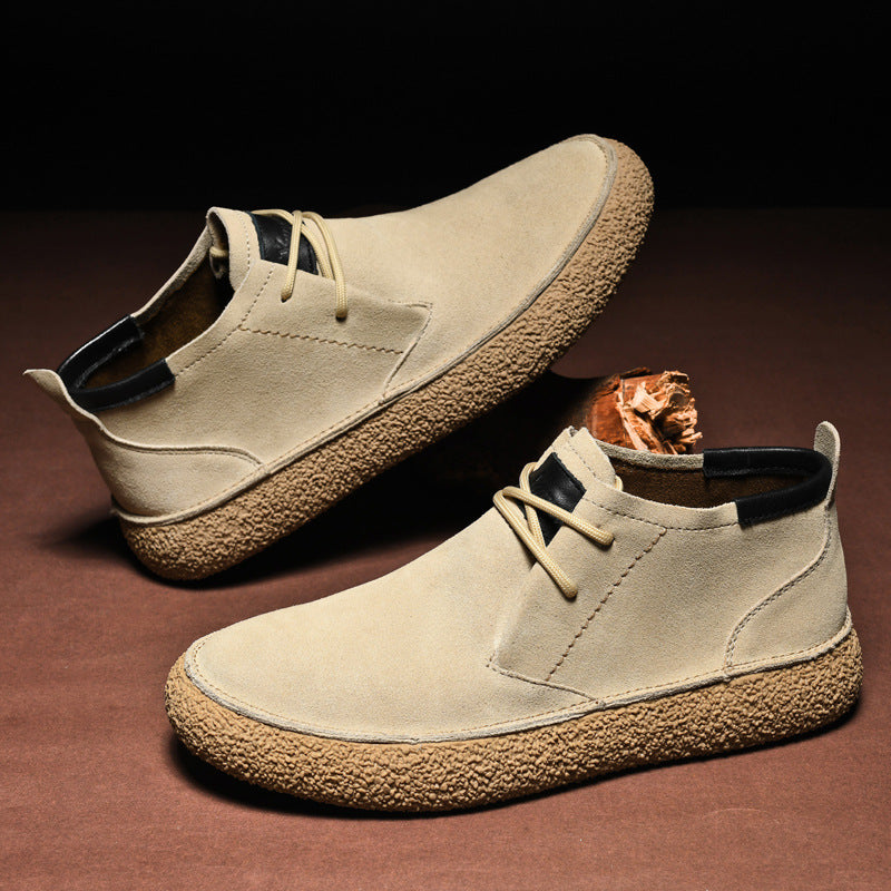 Men's lace-up chukka ankle boots with rounded toes, dark collar trim and textured soles