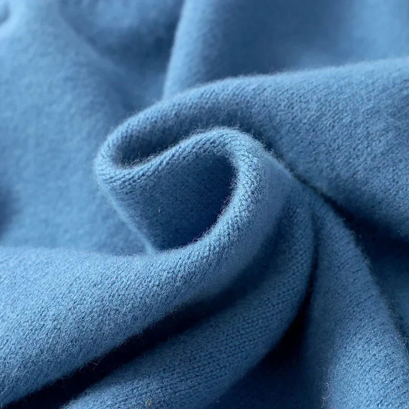 Men's textured knit crew neck sweater shown in light blue and black with long sleeves and ribbed edges