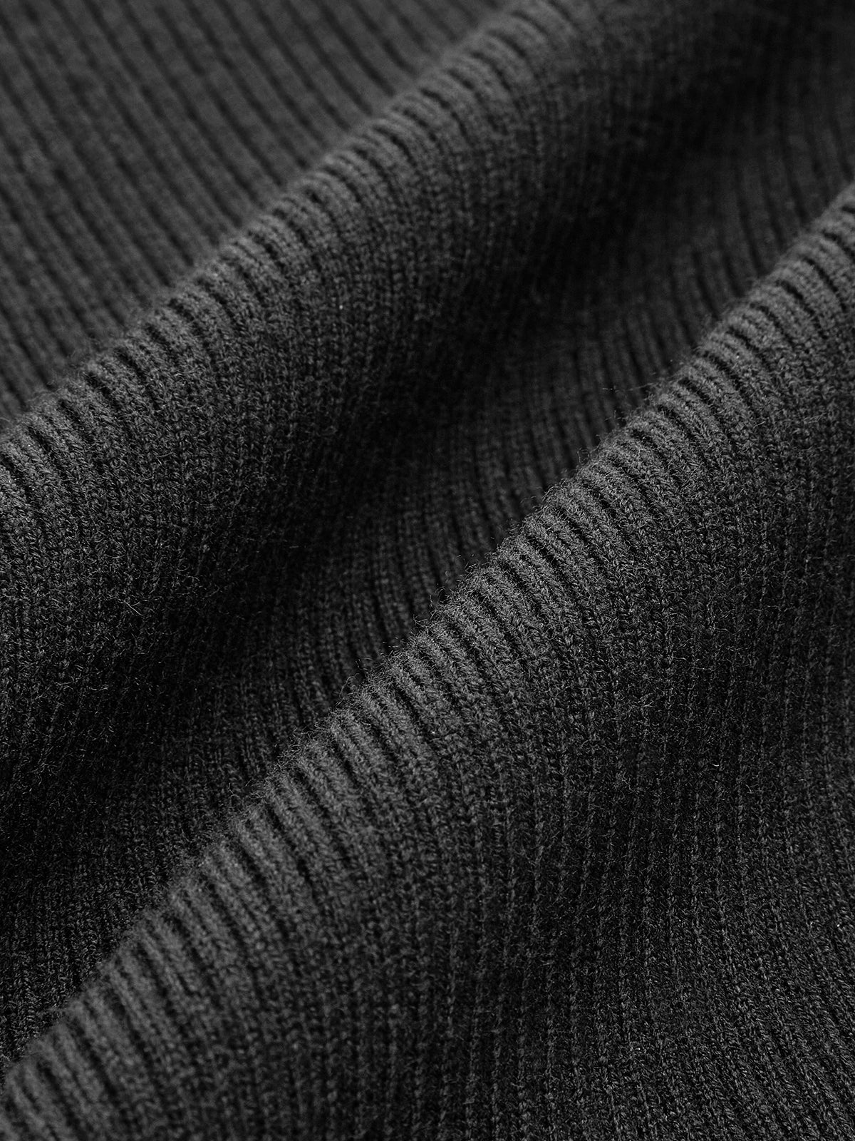 Women's black ribbed knit top with pearl-trimmed round collar and white contrast cuffs
