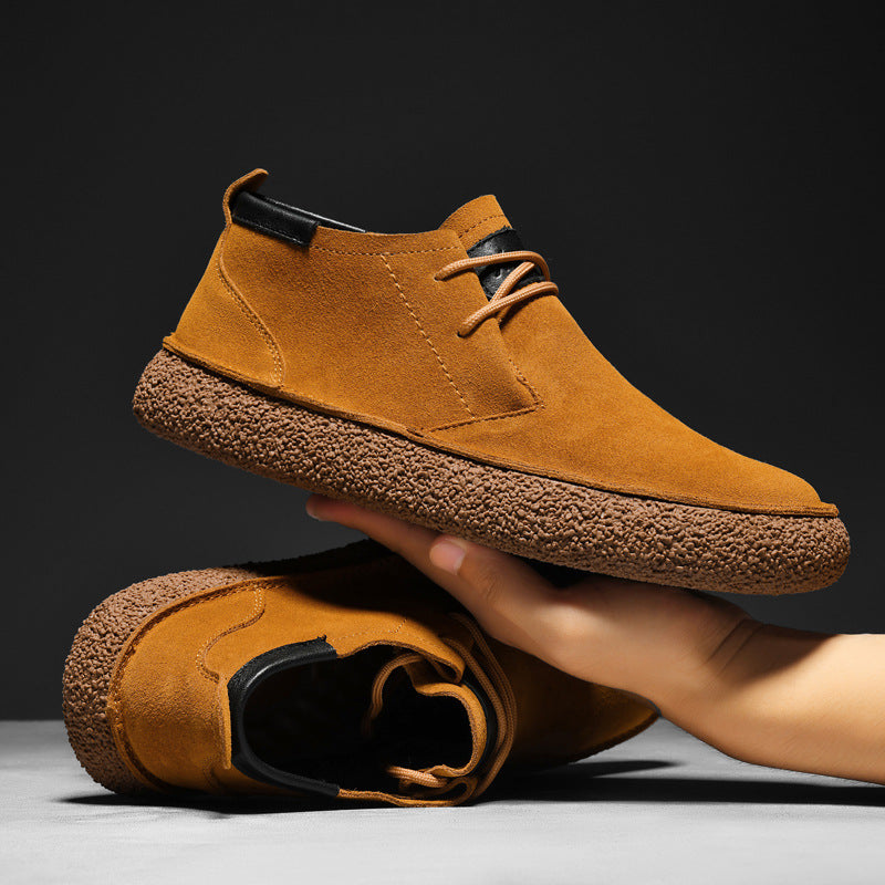 Men's lace-up chukka ankle boots with rounded toes, dark collar trim and textured soles