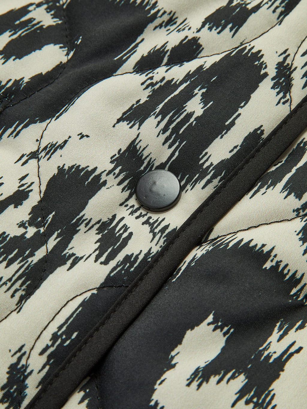 Women's black and white abstract animal print quilted collarless jacket